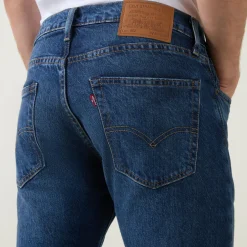 502™ Mid-Rise Tapered Jeans